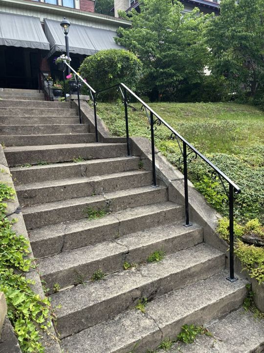 Black aluminum handrail with scroll supports in Highland Park